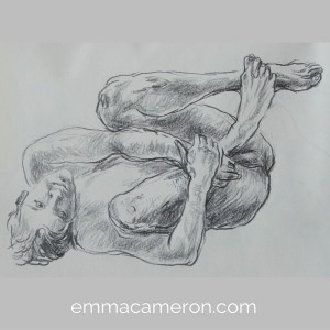 Life drawing of male model lying curled up